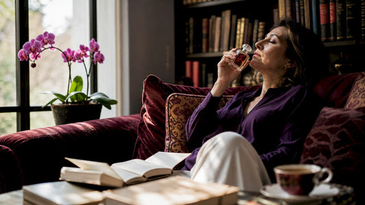 Woman smelling perfume recalling emotion