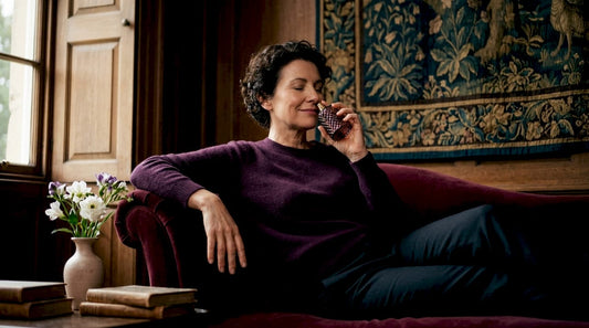 Woman inhaling scent to evoke memory