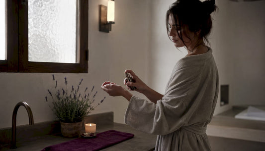 Woman applying perfume on damp skin after shower