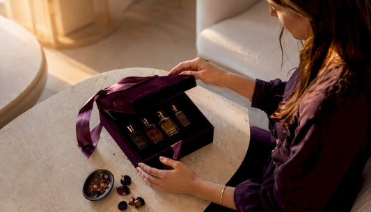 Une femme découvre avec émerveillement un coffret cadeau de parfums artisanaux.