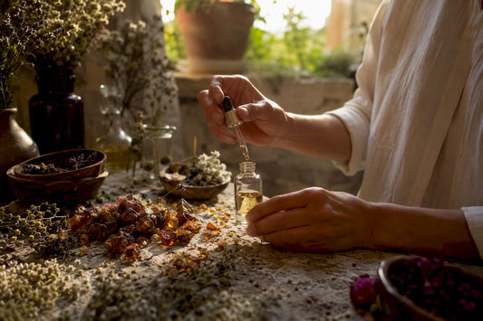 Hands blending natural perfume resins and oils