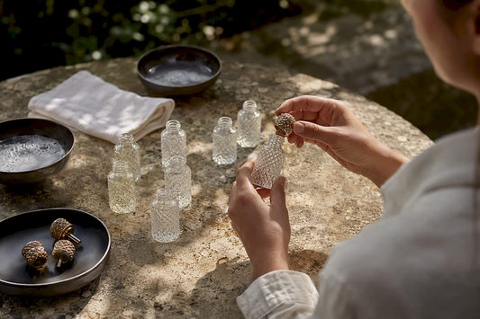 Hands cleaning and disassembling perfume bottles
