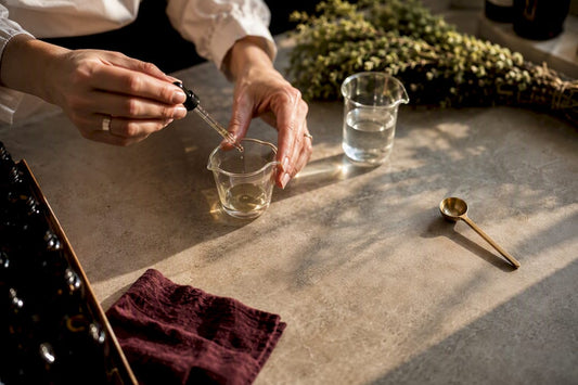 Perfumer measuring botanical essence in atelier