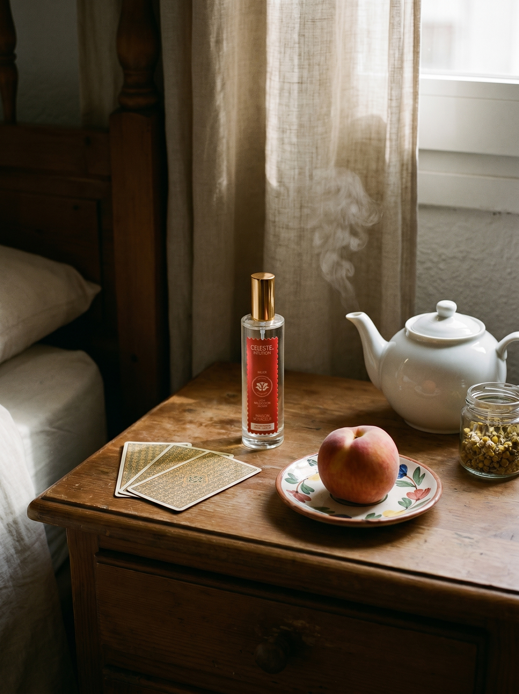 Intuition eau de parfum 100ml lifestyle on Madrid bedside table with tarot cards peach and white tea pot — Maison Voyageur Mediterranean artisanal parfumerie