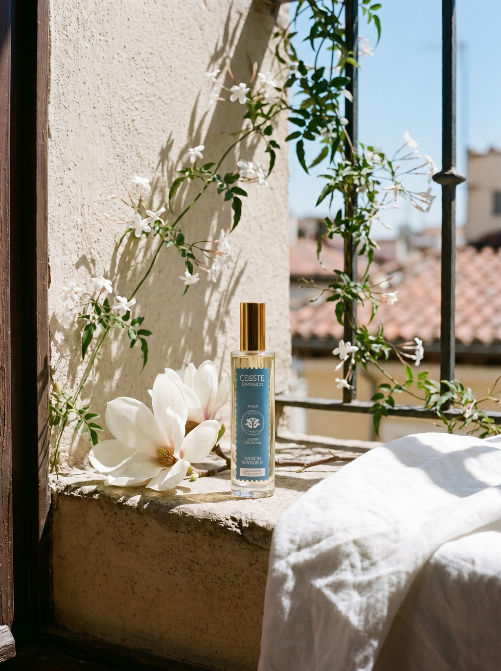 Expansion eau de parfum 100ml lifestyle on Madrid windowsill with magnolia branch and jasmine vine — Maison Voyageur Mediterranean artisanal parfumerie women